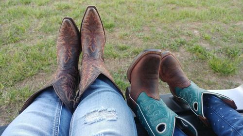 Low section of mother and daughter wearing shoes