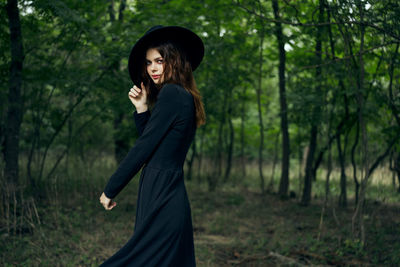 Young woman standing in forest