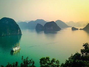 Scenic view of calm sea against mountain range