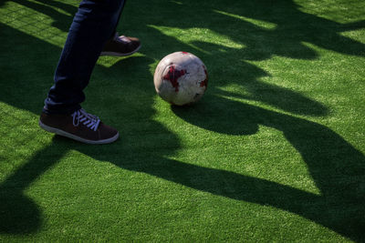 Low section of man standing on soccer field