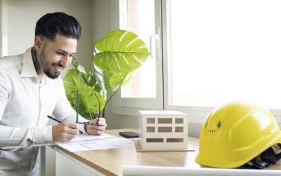 Young man with text on table