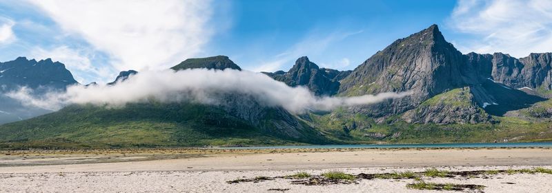 Panoramic view of land and mountains against sky