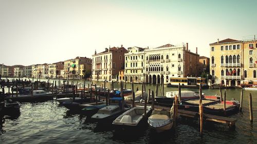 Boats in canal with buildings in background