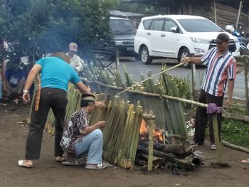 People standing by car