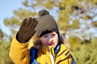 Portrait of cute girl gesturing outdoors