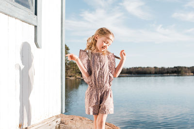 Young girl dancing using her imagination on her own at the beach