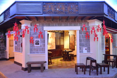 Chairs and tables in restaurant against building