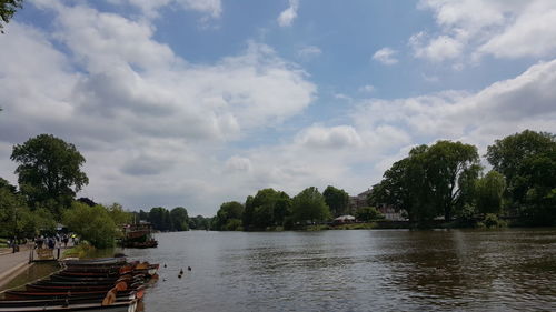 Scenic view of river against cloudy sky