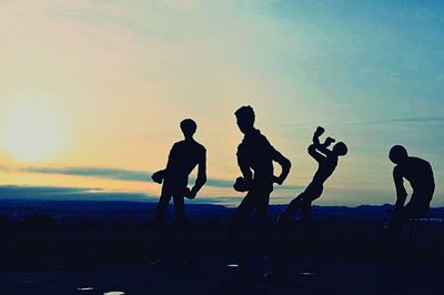 Silhouette of people at sunset