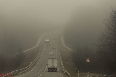 Vehicles on road during foggy weather