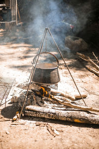 Kettle hanging above fire in nature