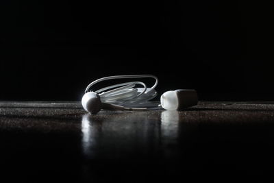 Close-up of eyeglasses on table against black background