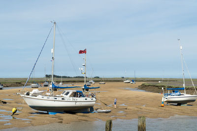 Boats moored on sea against sky