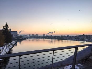 Scenic view of river against sky during sunset