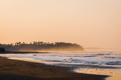 Scenic view of sea against clear sky during sunset