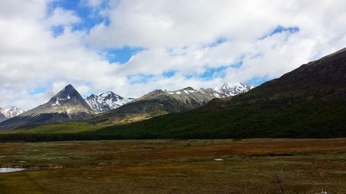 Scenic view of mountains against cloudy sky