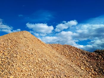 Low angle view of stone stuff against blue sky