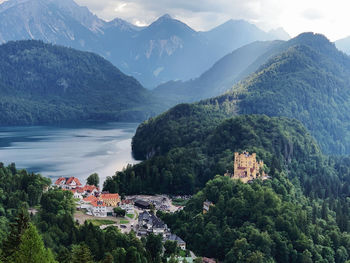 High angle view of townscape by mountains against sky