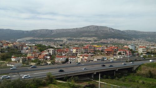 High angle view of road by buildings against sky