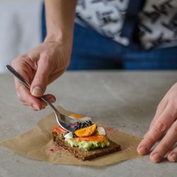 Midsection of person having food on table