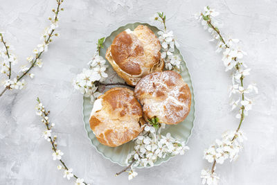Choux buns with whipped cream and sugar powder on top. choux pastry dessert. french cream puffs
