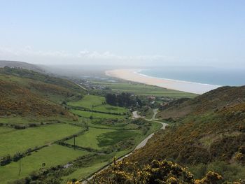 High angle view of landscape with sea under blue sky