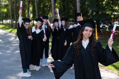 Rear view of woman wearing graduation gown