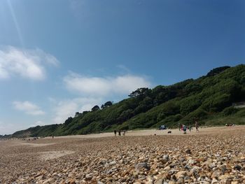 Group of people on landscape against sky