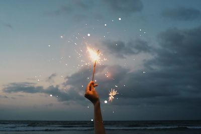 Low section of woman standing at beach