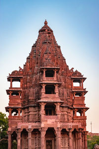 Ancient hindu temple architecture with bright sky from unique angle at day