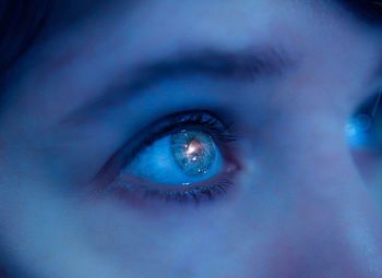 Digital composite image of orion nebula in woman eye