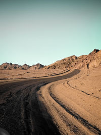 Scenic view of desert against clear blue sky