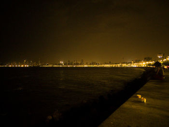 Illuminated city at waterfront