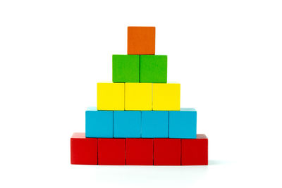 Stack of multi colored toy against white background