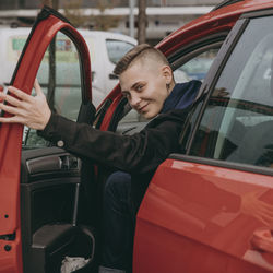 Side view of man sitting in car