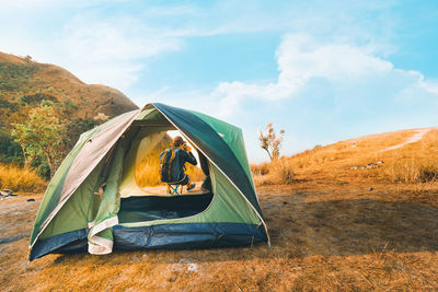 Scenic view of tent on field against sky