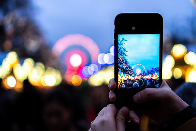 Cropped hand of woman using mobile phone