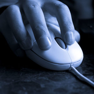 Close-up of person using laptop on table