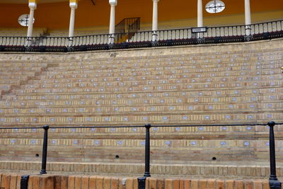 View of brick wall with building in background