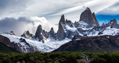 Scenic view of mountains against cloudy sky