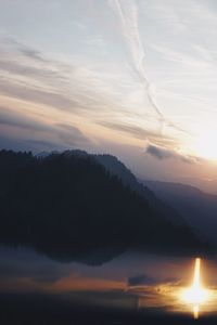 Scenic view of silhouette mountains against sky at sunset