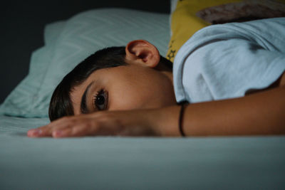 Portrait of sleepy boy in bed