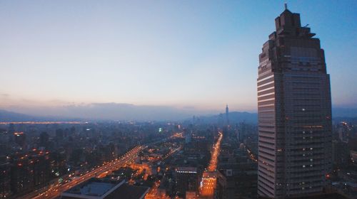 Illuminated cityscape against sky