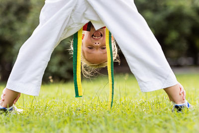 Portrait of young woman standing on field