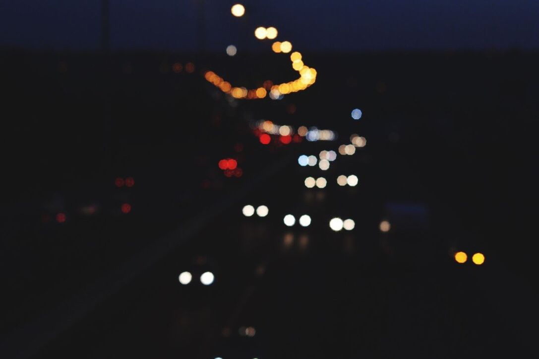 DEFOCUSED LIGHTS IN CITY AT NIGHT