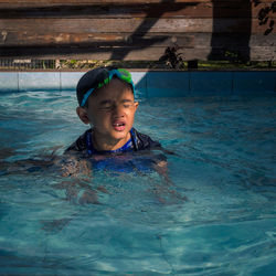 Portrait of boy swimming in pool