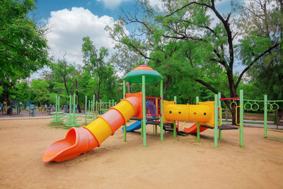 View of playground against trees in park