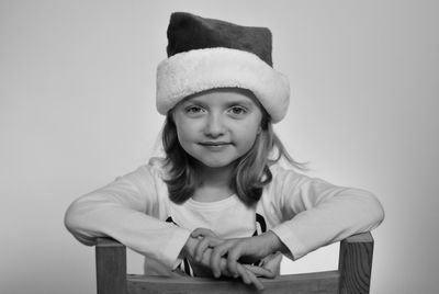 Portrait of girl wearing hat against white background