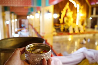 Close-up of hand holding drink in restaurant