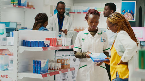 Female doctor examining chemical in laboratory